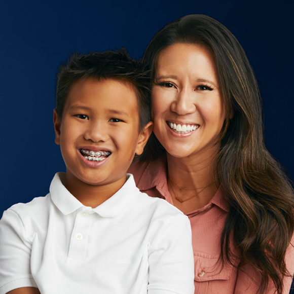 Mom and young boy in braces smiling